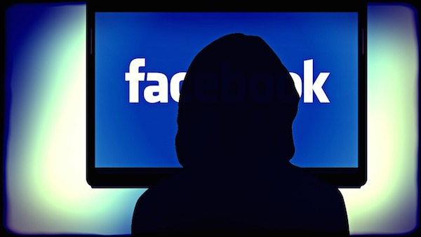 Immagine che mostra una donna dinanzi ad un monitor con il logo di Facebook